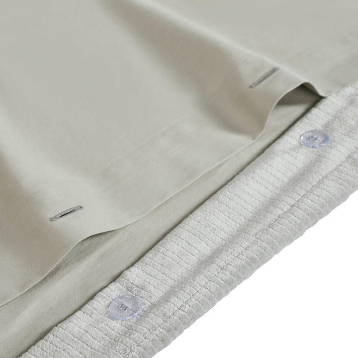 DT-054-9092_8|Detail of the light grey velvet corduroy textured duvet cover with durable button closure and smooth reverse fabric.