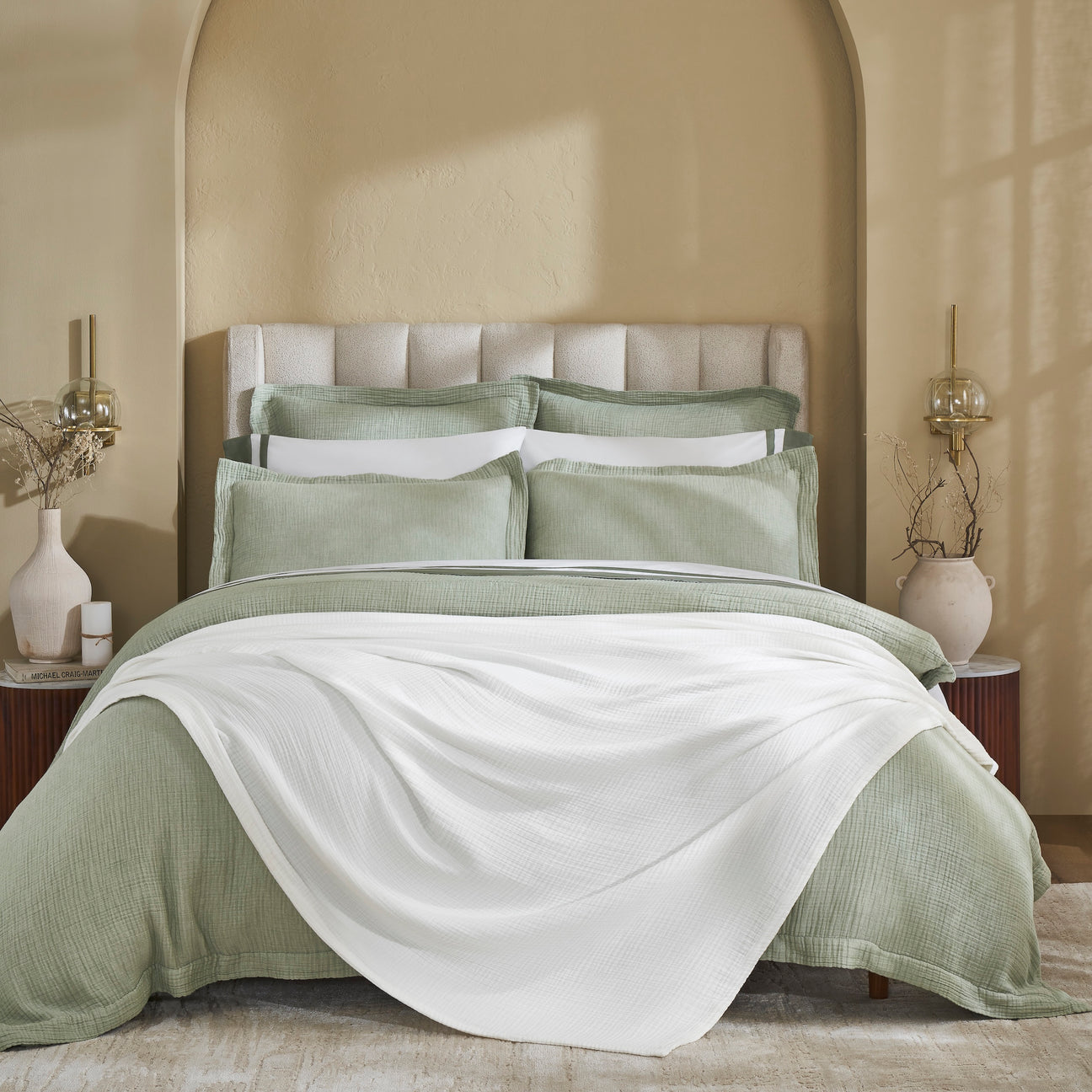 BL-861-11096_1|Crisp white textured blanket gracefully draped over a serene bed with soft green bedding, enhancing cozy modern bedroom decor.