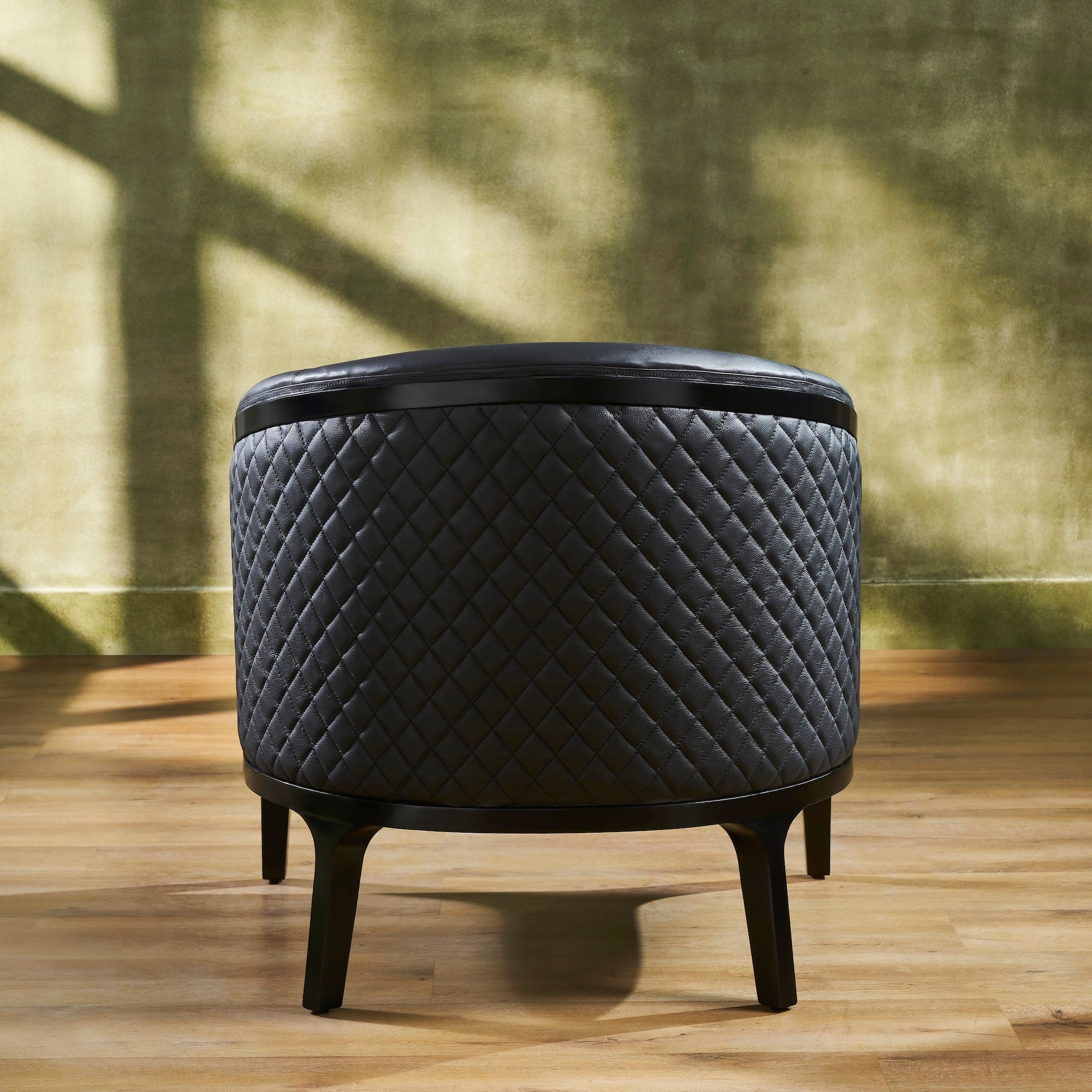 FN-5205-343329_5|Sophisticated black leather round ottoman with diamond quilted pattern and dark wooden legs, a versatile accent piece.