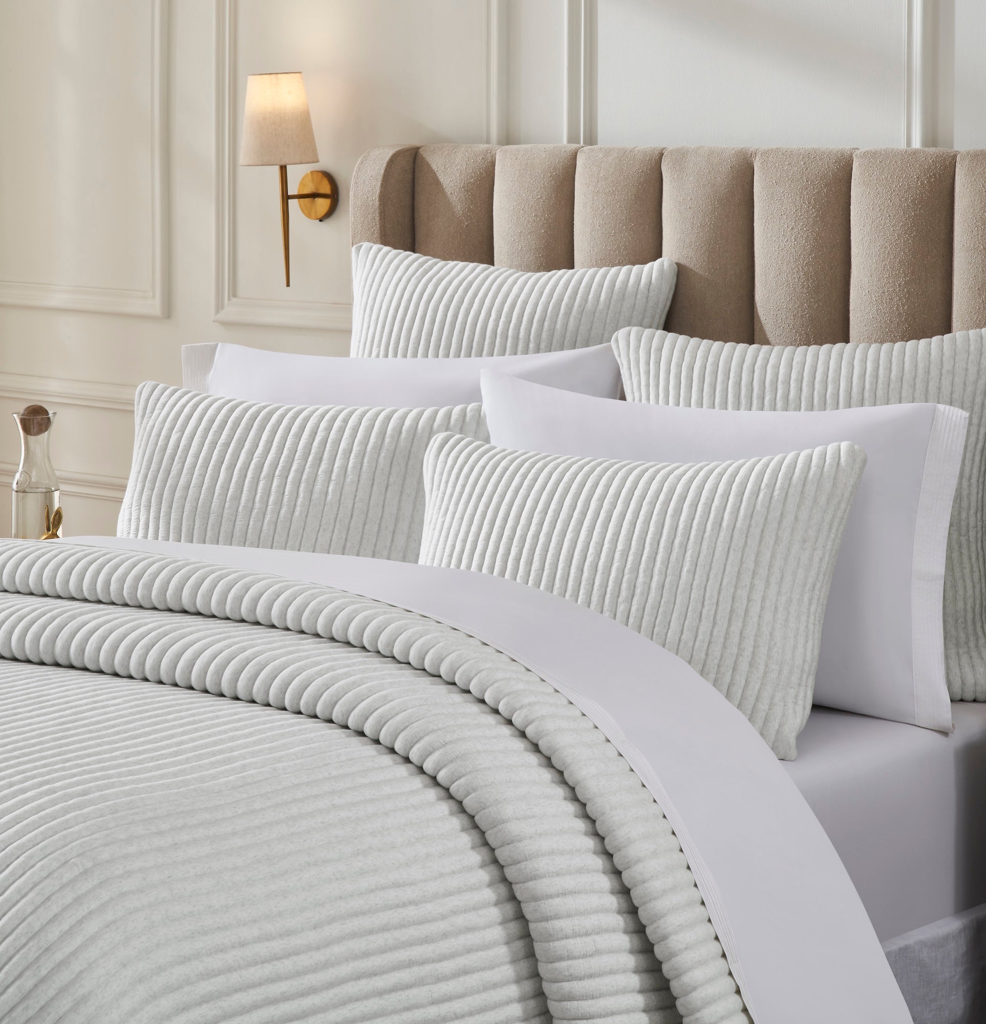 QT-374-11096_3|Close-up of soft light grey ribbed quilt and pillows, highlighting the elegant bedding for a serene and comfortable bedroom.