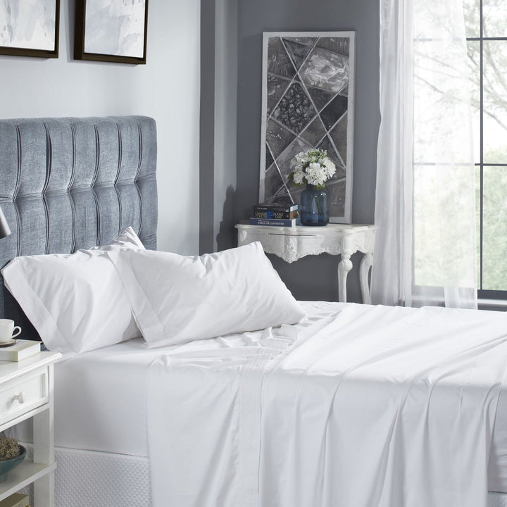 CSS-520-7284_2|Comfortable white 100% cotton sheet set on a beautifully made bed, featuring subtle decorative trim for elegance.
