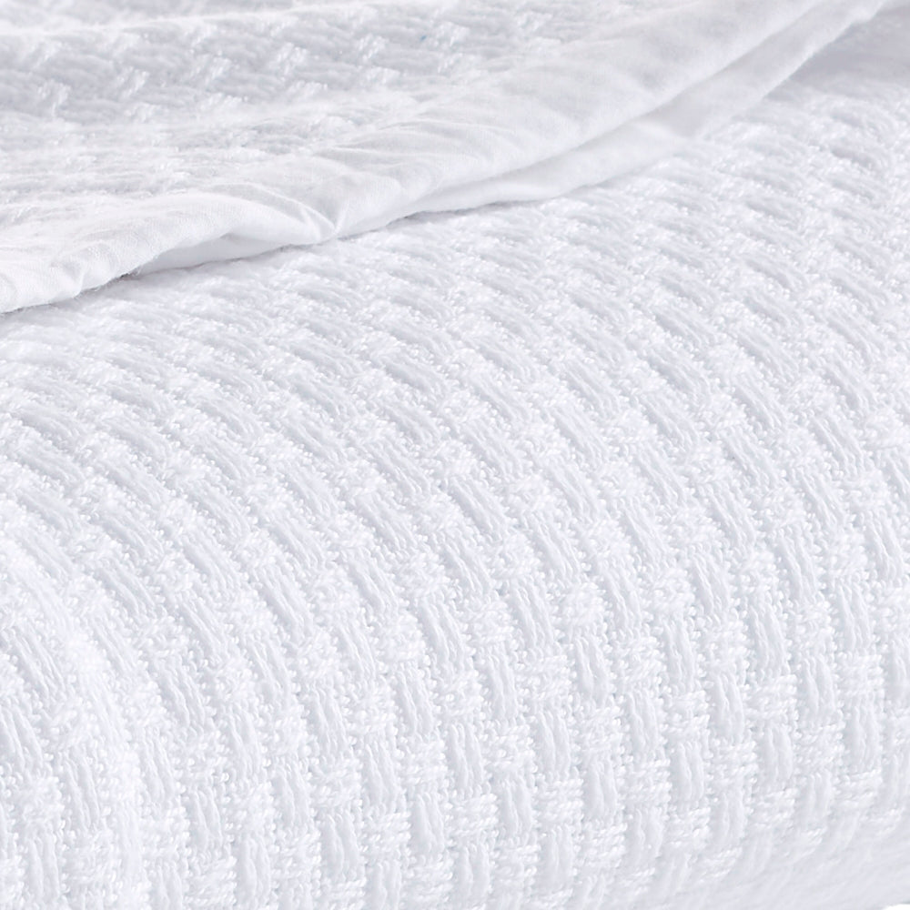 SWT-851-7.8_1|Cozy white woven blanket, elegantly folded, showcasing a rich basketweave texture. Perfect for warmth and comfort.