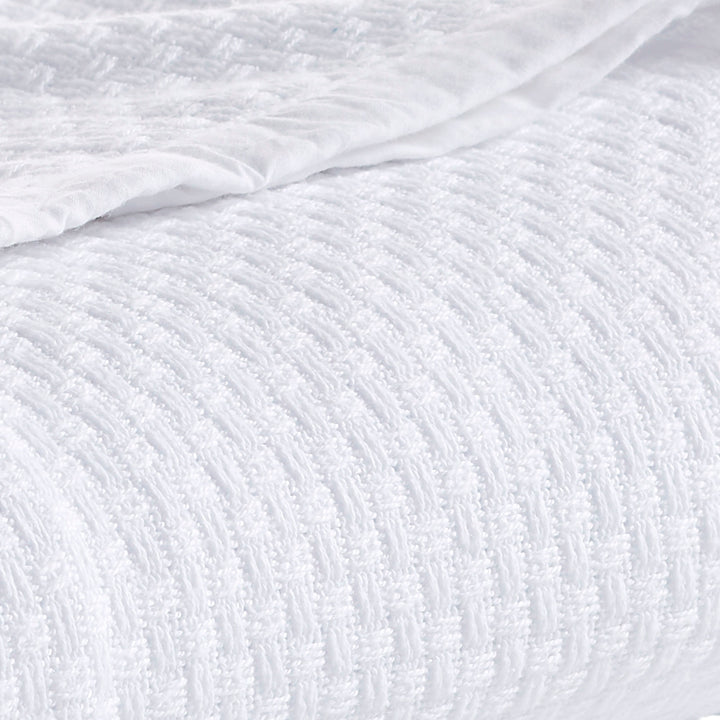 SWT-851-7.8_1|Cozy white woven blanket, elegantly folded, showcasing a rich basketweave texture. Perfect for warmth and comfort.