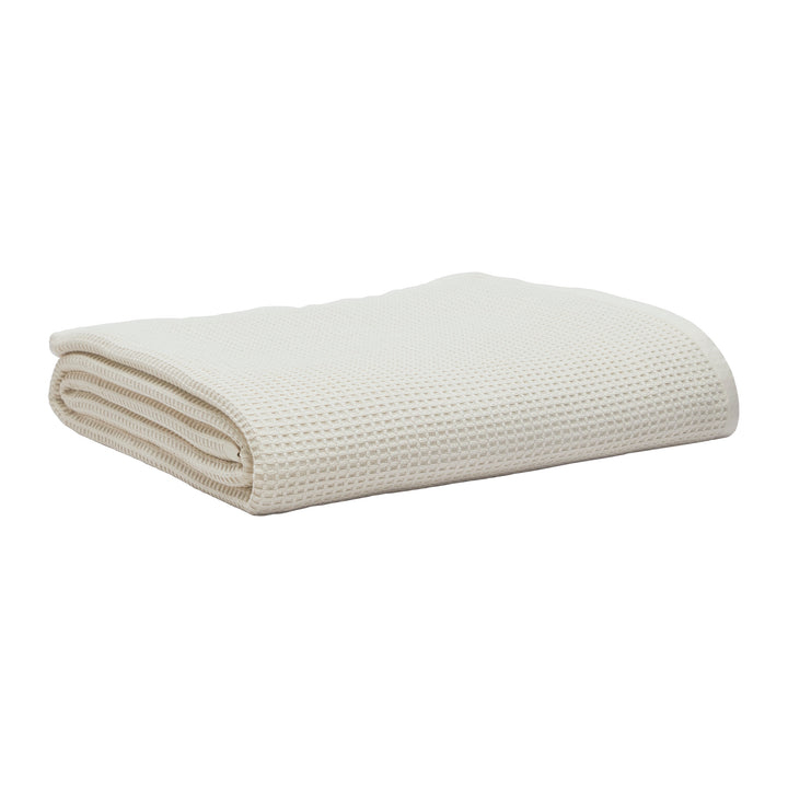 BL-867-11096_3|Folded cream waffle weave blanket. Soft, breathable cotton throw blanket for bed or sofa, adding texture and warmth to any room.