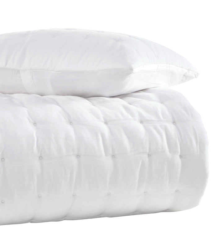 QT-353-11096_3|Stack of a white quilted comforter and matching pillow, highlighting plush texture and clean modern design. Soft bedding.