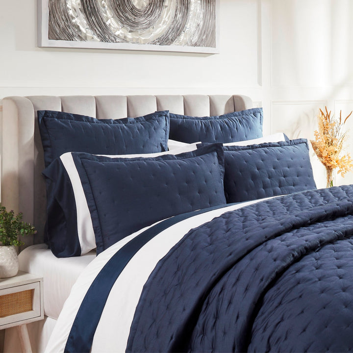 QT-357-11096_3|Close-up of a luxurious navy blue quilted quilt and shams, showcasing intricate stitching and soft fabric. Premium bedding.