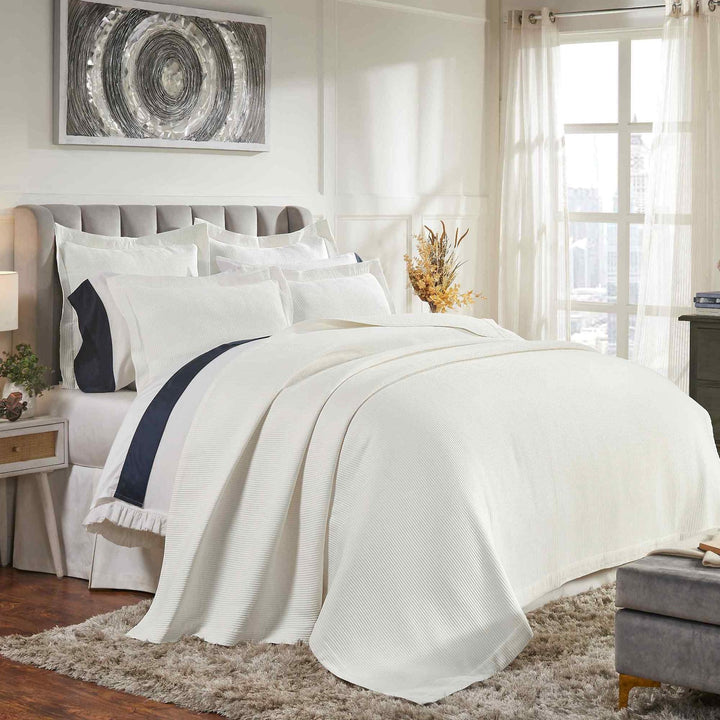 CL-192-9496_2|Elegant white striped coverlet gracefully draped across a bed, adding sophisticated texture to a stylish bedroom.