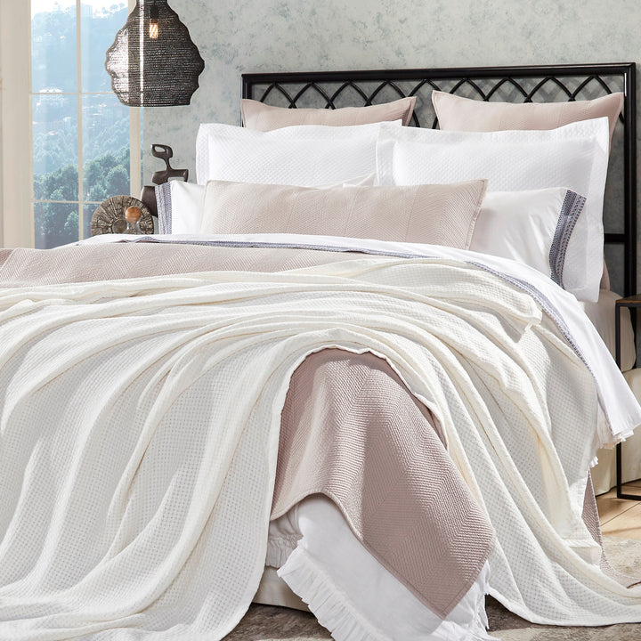 BL-852-9496_1|Draped white waffle weave blanket on a cozy bed with neutral bedding, adding a luxurious texture to bedroom decor.