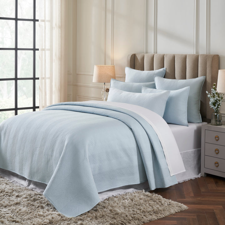 CL-262-11096_2|Cozy light blue quilted coverlet featuring a chic herringbone pattern, adorning a bed in a bright, modern bedroom.