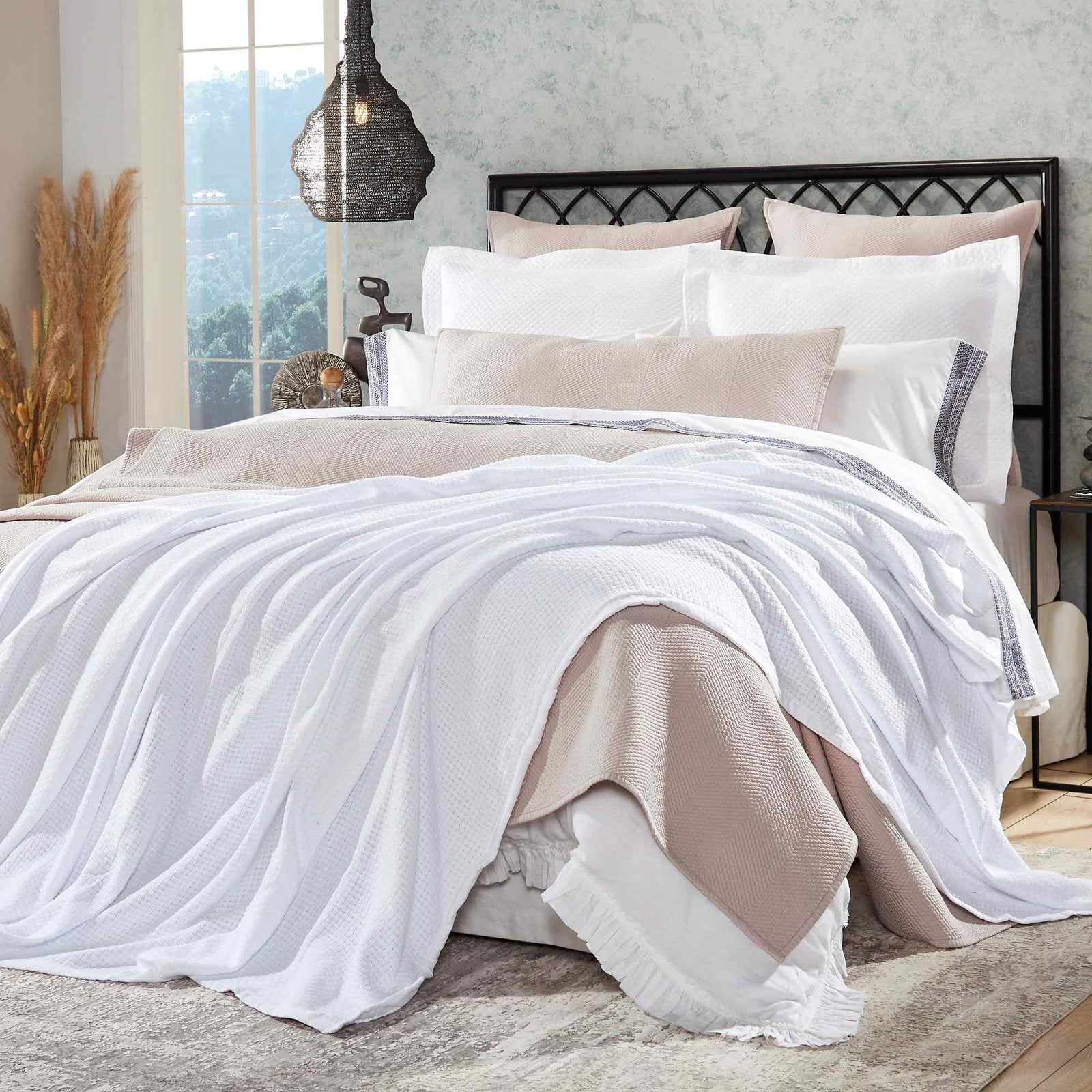 BL-851-X_1|Plush white waffle weave blanket elegantly draped on a bed, offering supreme comfort and style.