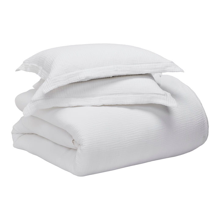 SS-048-2026_4|Complete white organic cotton duvet cover set, including a folded duvet cover and two matching pillow shams.