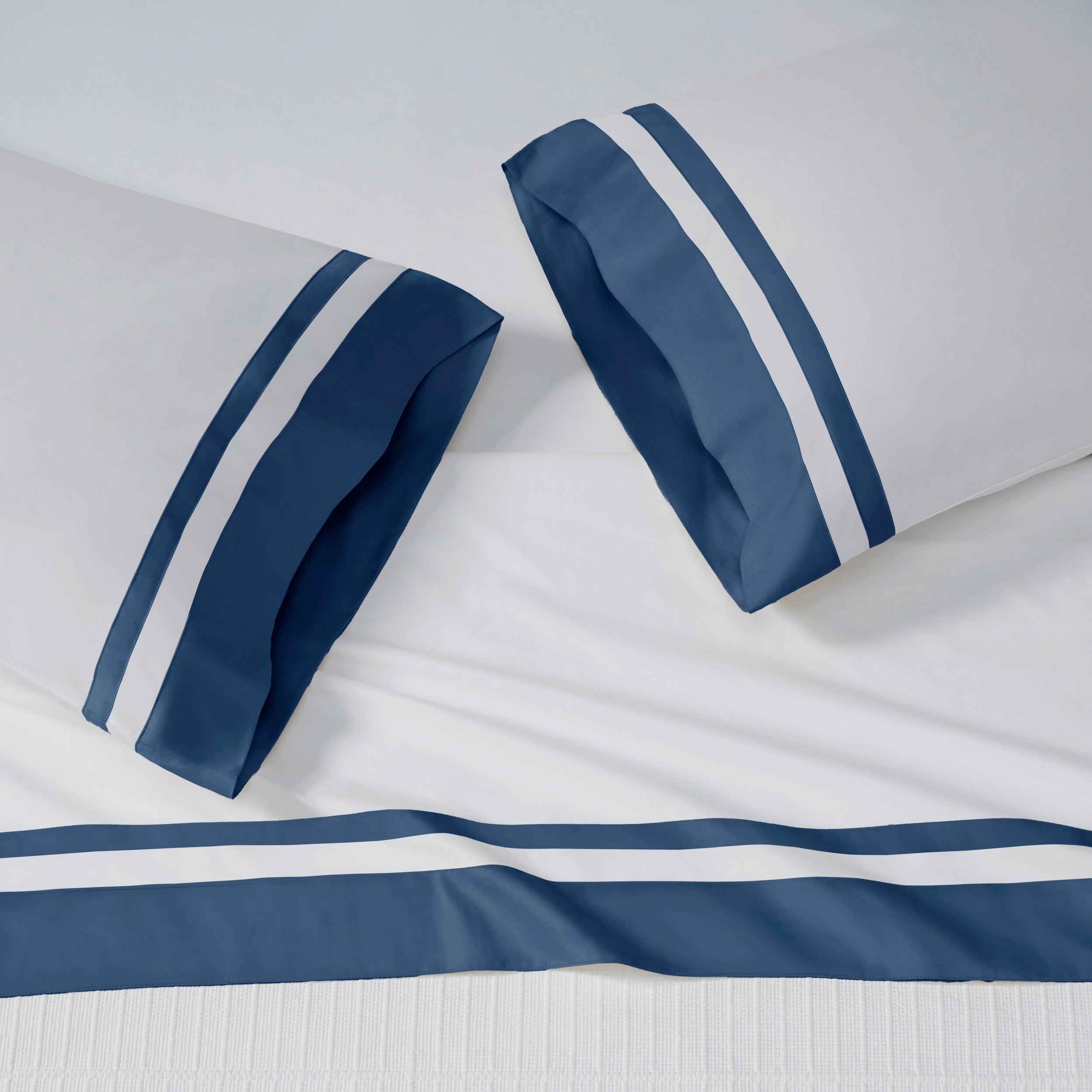 ASP-548-2032_2|White 100% cotton sateen sheet set with a navy blue double stripe border on flat sheet and two pillowcases.