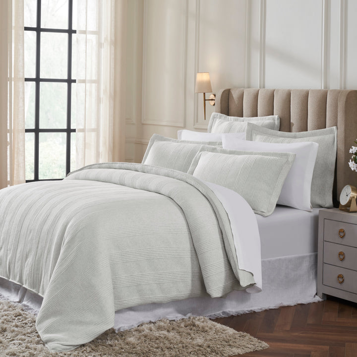 DT-043-9092_2|Elegant light grey ribbed duvet cover set on a bed, with matching shams and pillows for a luxurious bedroom aesthetic.