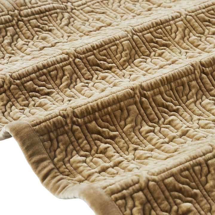 QT-377-11096_7|Detailed close-up of a tan quilted bedspread's corner, highlighting its embossed geometric pattern and soft, luxurious texture.