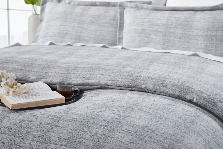 DT-035-10692_4|Relaxed gray textured duvet cover draped elegantly on a bed, suggesting comfort and serene modern bedroom ambiance.