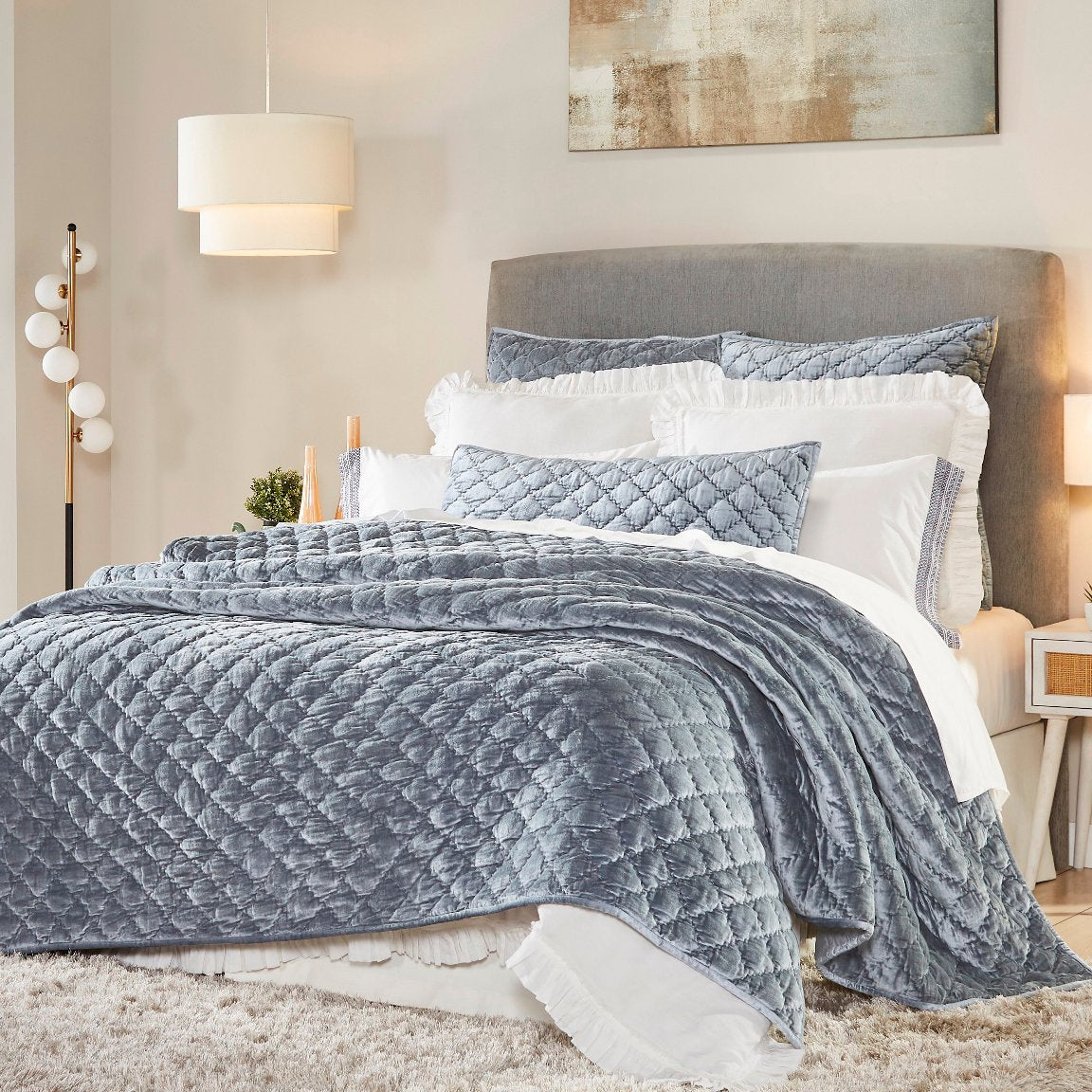 QT-341-11096_1|Luxurious blue velvet quilted quilt and shams, diamond pattern, draped elegantly over a bed. Chic bedroom decor.