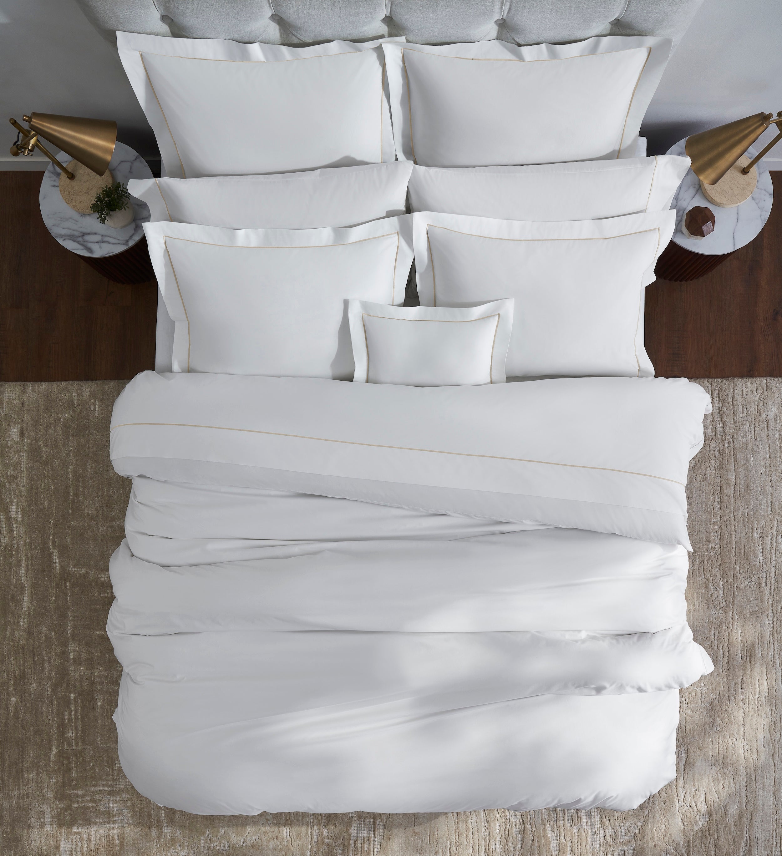 DT-056-6886_3|Crisp white duvet cover with elegant gold border, partially folded on a bed for a luxurious, inviting bedroom setup.