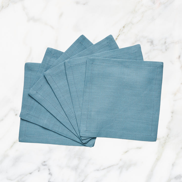 CNP-4902-66_1|Fanned set of stylish turquoise blue linen napkins on white marble. Perfect for modern, elegant table settings & home decor.