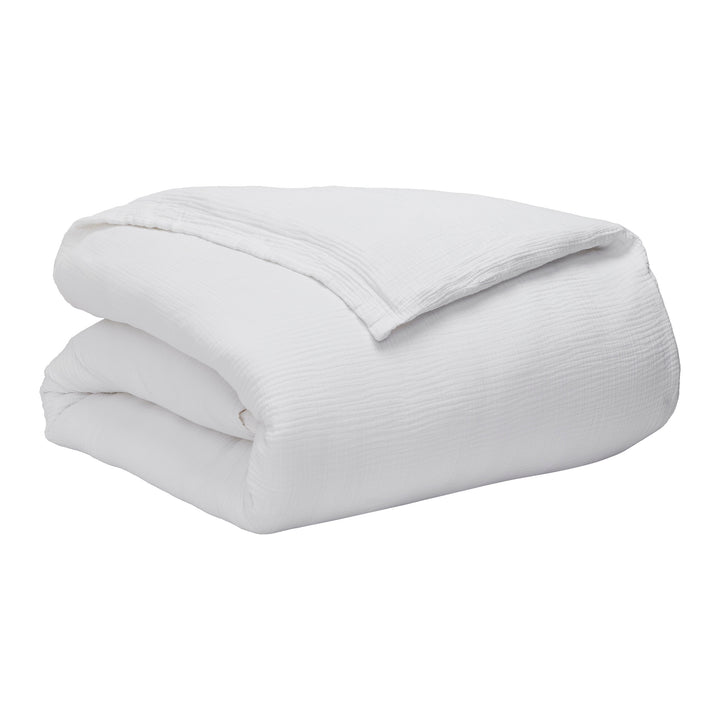 DT-048-10692_10|White textured gauze duvet cover, neatly folded, showcasing its soft, crinkled fabric. Ideal for a comfortable, stylish bed.