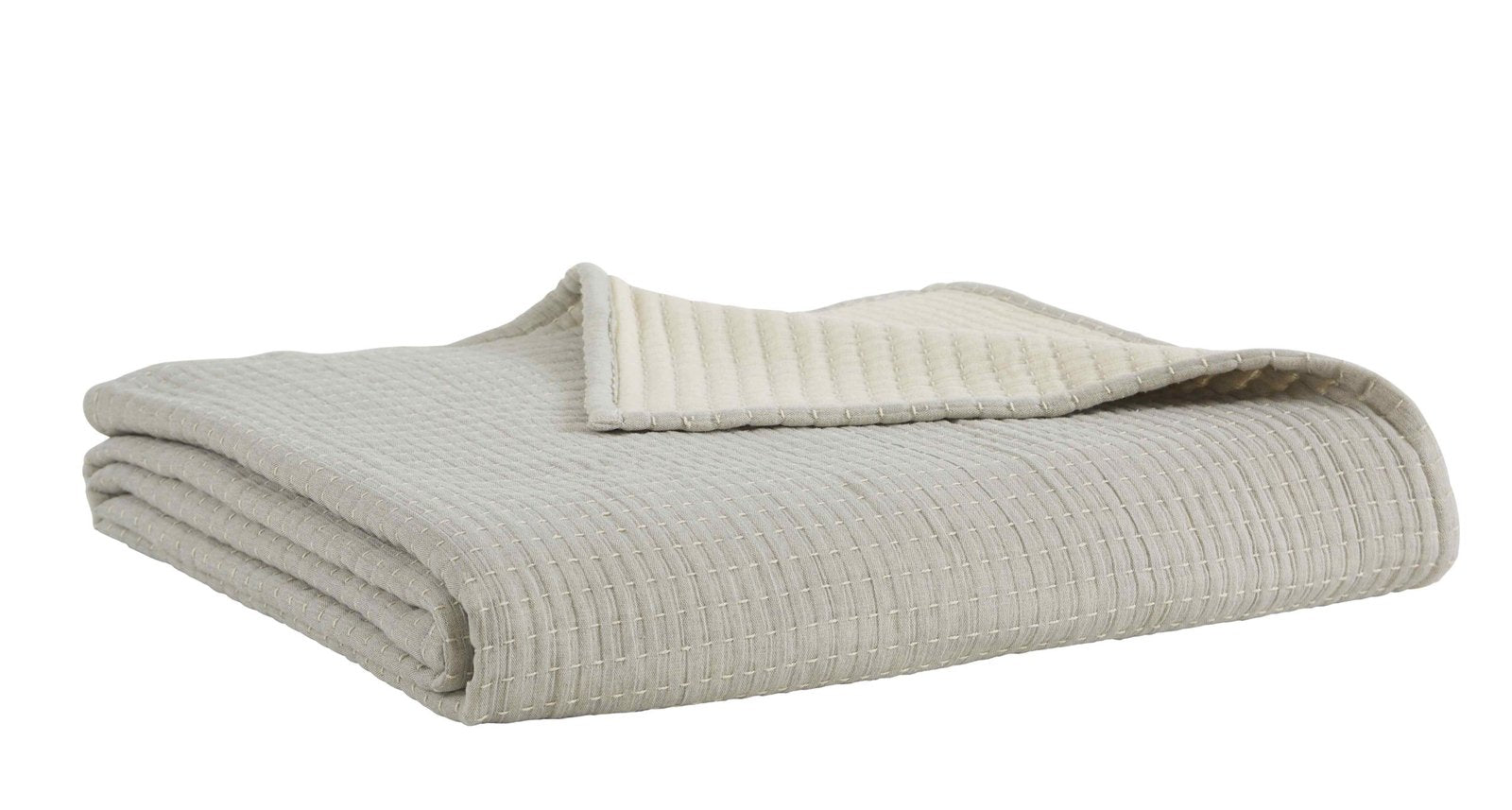 BT-107-11096_3|Cream textured reversible quilt blanket, folded neatly, showcasing soft cream reverse for cozy bed and neutral home decor.