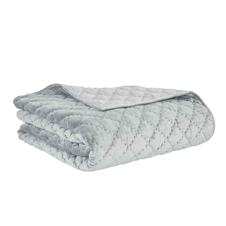 QT-356-11096_7|Reversible light blue-grey velvet quilt with intricate diamond quilting, elegantly folded, showcasing its soft texture.