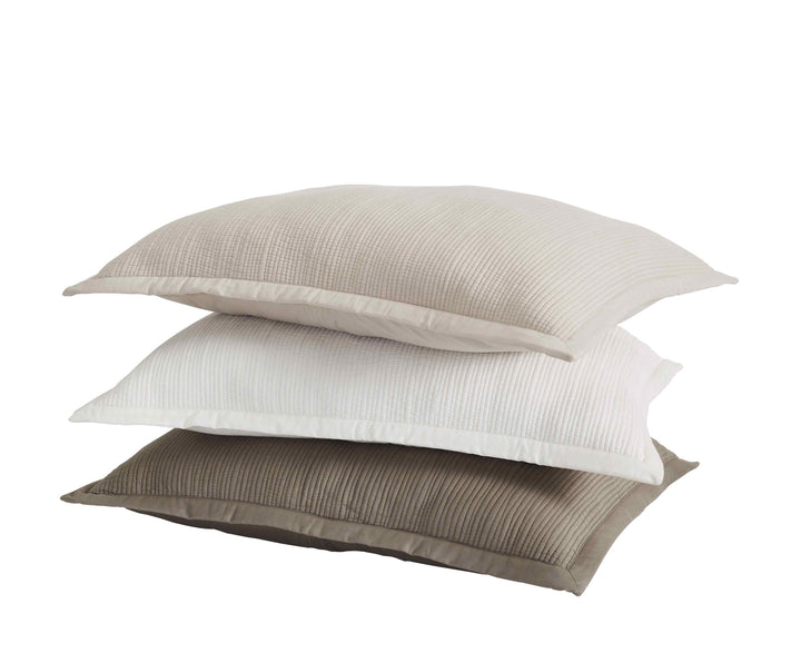 KS-168-2036_3|Three stacked quilted coverlet pillows in neutral tones of light beige, white, and dark beige. Soft, textured bedding.