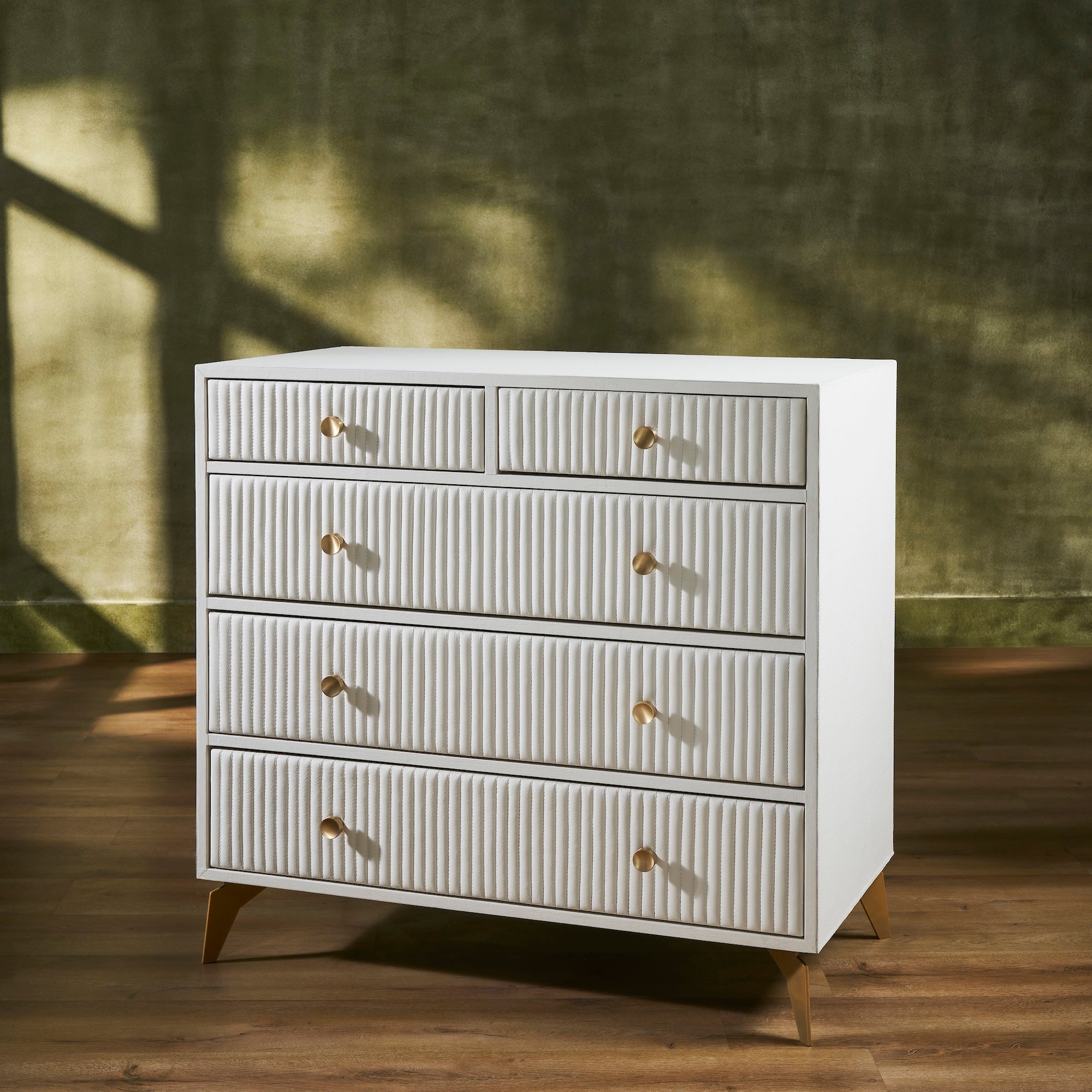 FN-5216-482036_2|Stylish cream ribbed leather dresser with golden pulls and tapered legs, a contemporary piece for spacious bedroom storage.