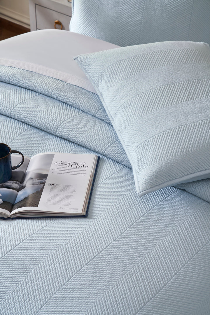 CL-262-9496_4|Luxurious light blue quilted coverlet with a distinctive herringbone pattern, perfect for a cozy and inviting bedroom.