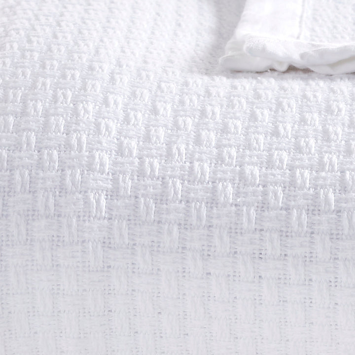 BL-855-9496_4|Close-up of the white woven blanket, highlighting its beautiful basketweave texture for a luxurious feel.