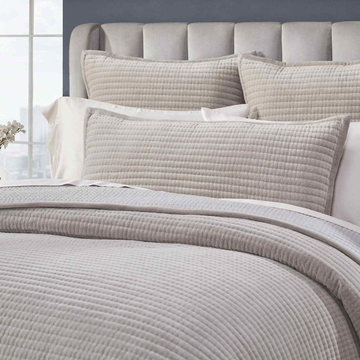 CL-188-11096_5|Close-up of a grey quilted coverlet and matching pillow sham, exhibiting a delicate channel quilt texture.