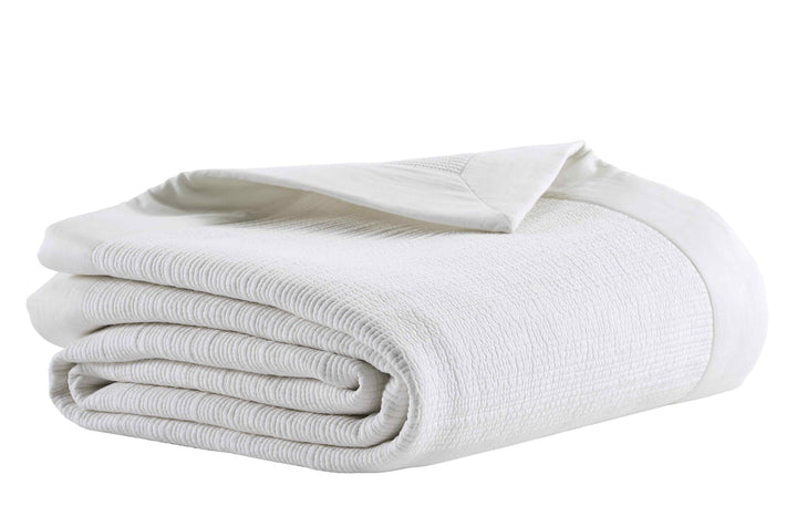 CL-168-9496_4|Folded white textured cotton blend coverlet, perfect for a cozy and elegant bedroom. High-quality bedding.