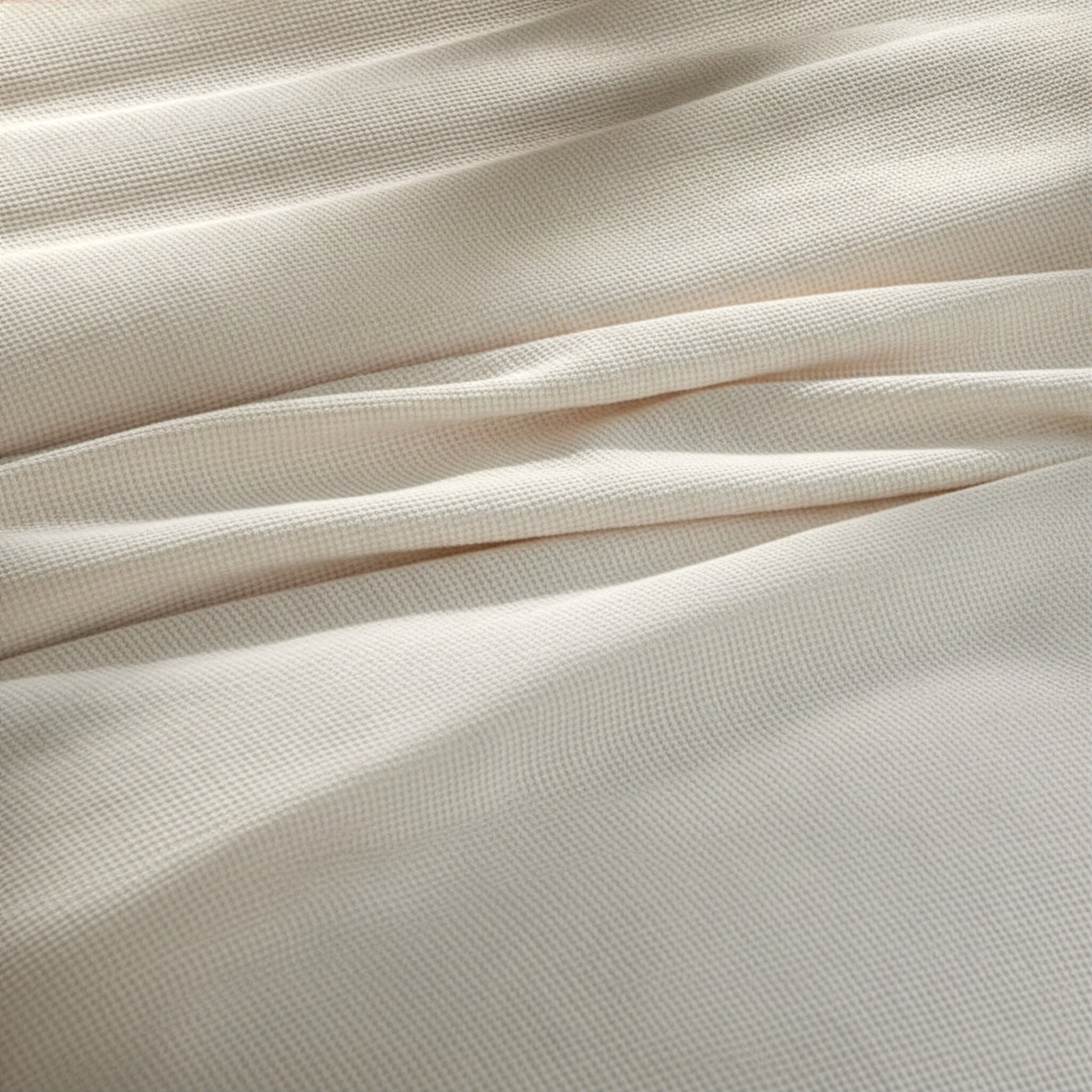 BL-860-11096_5|Close-up of a luxurious cream waffle weave blanket fabric, showcasing its intricate, soft texture and cozy feel. High-quality.