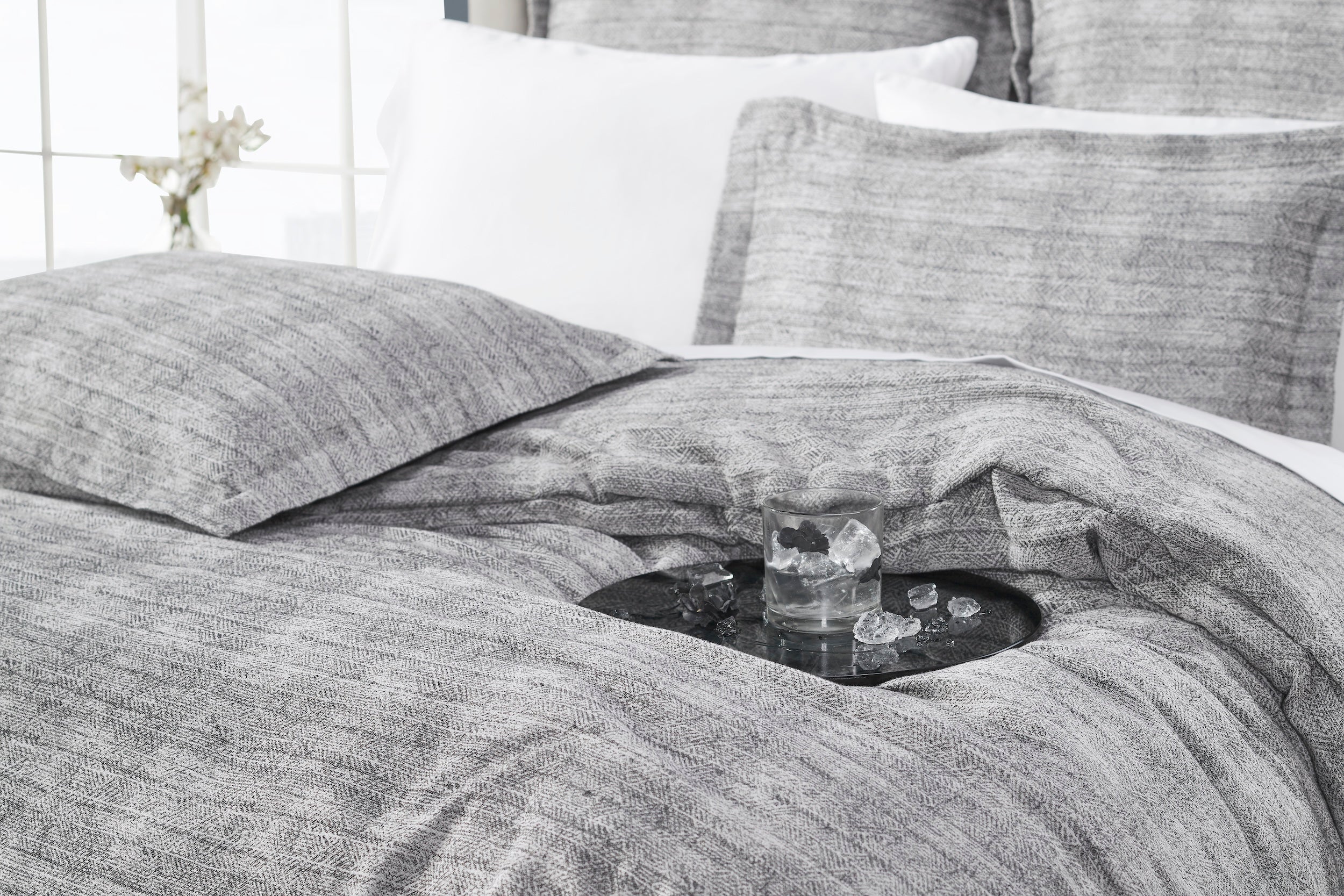 DT-034-9092_4|Relaxed gray textured duvet cover draped elegantly on a bed, suggesting comfort and serene modern bedroom ambiance.