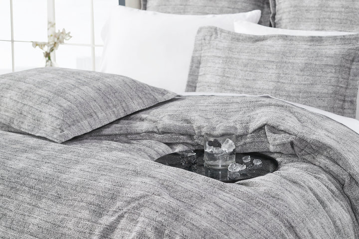 DT-034-9092_4|Relaxed gray textured duvet cover draped elegantly on a bed, suggesting comfort and serene modern bedroom ambiance.