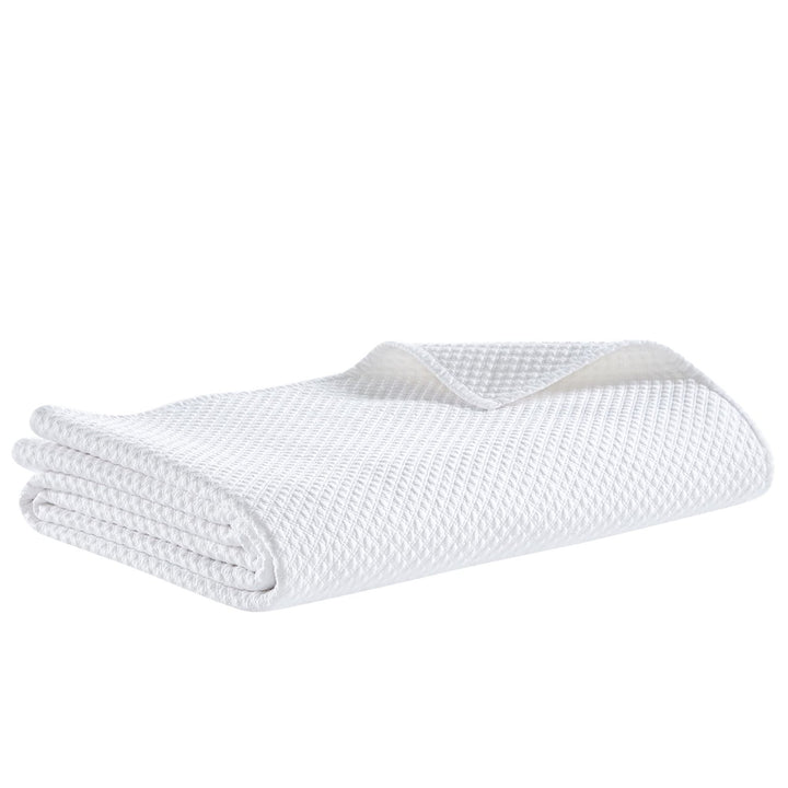 CL-200-11096_6|Close-up of a white textured coverlet fabric, highlighting the intricate diamond pattern and soft, inviting weave.