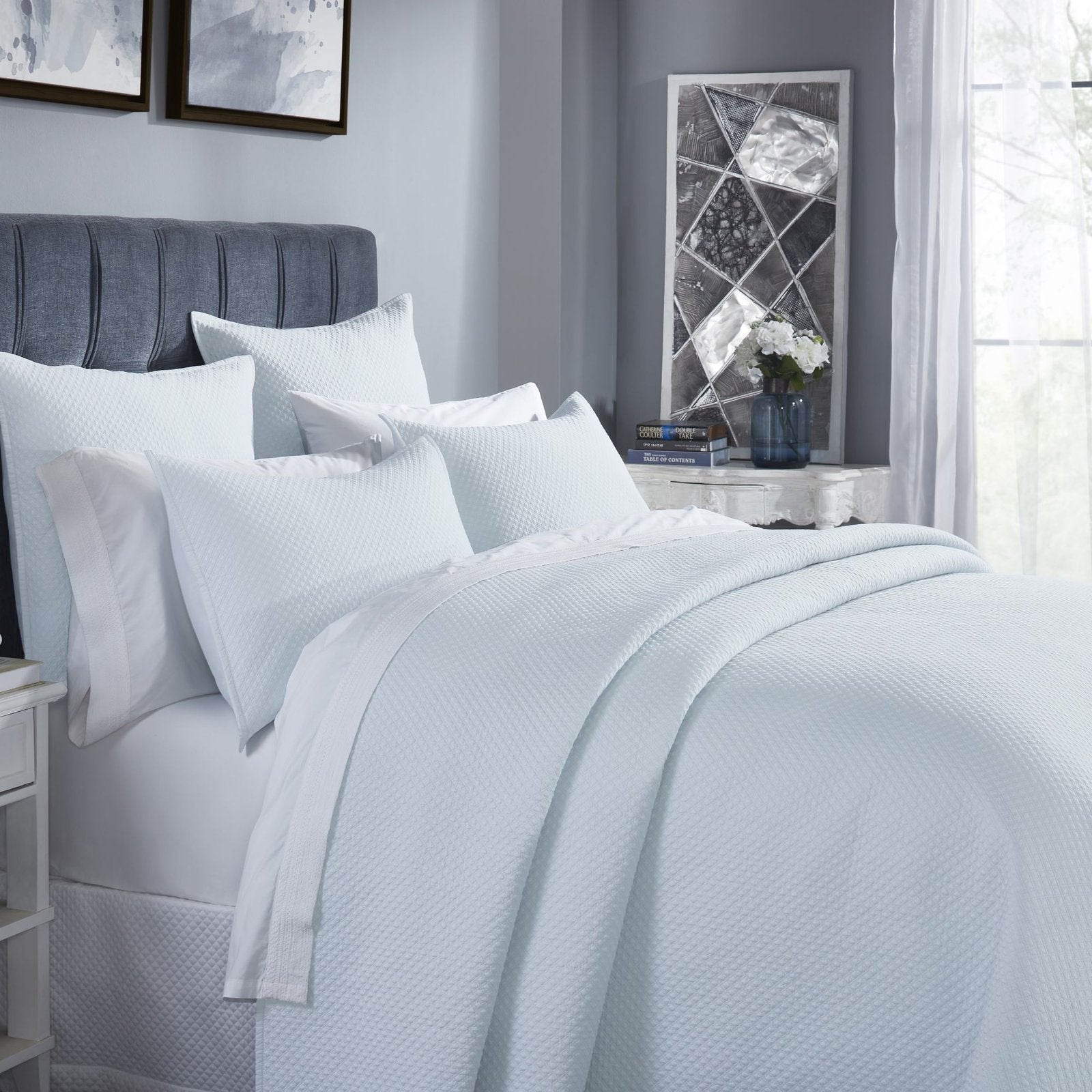 CL-251-11096_3|Close-up of a beautifully arranged light blue textured coverlet on a queen bed, showcasing its soft, inviting feel.