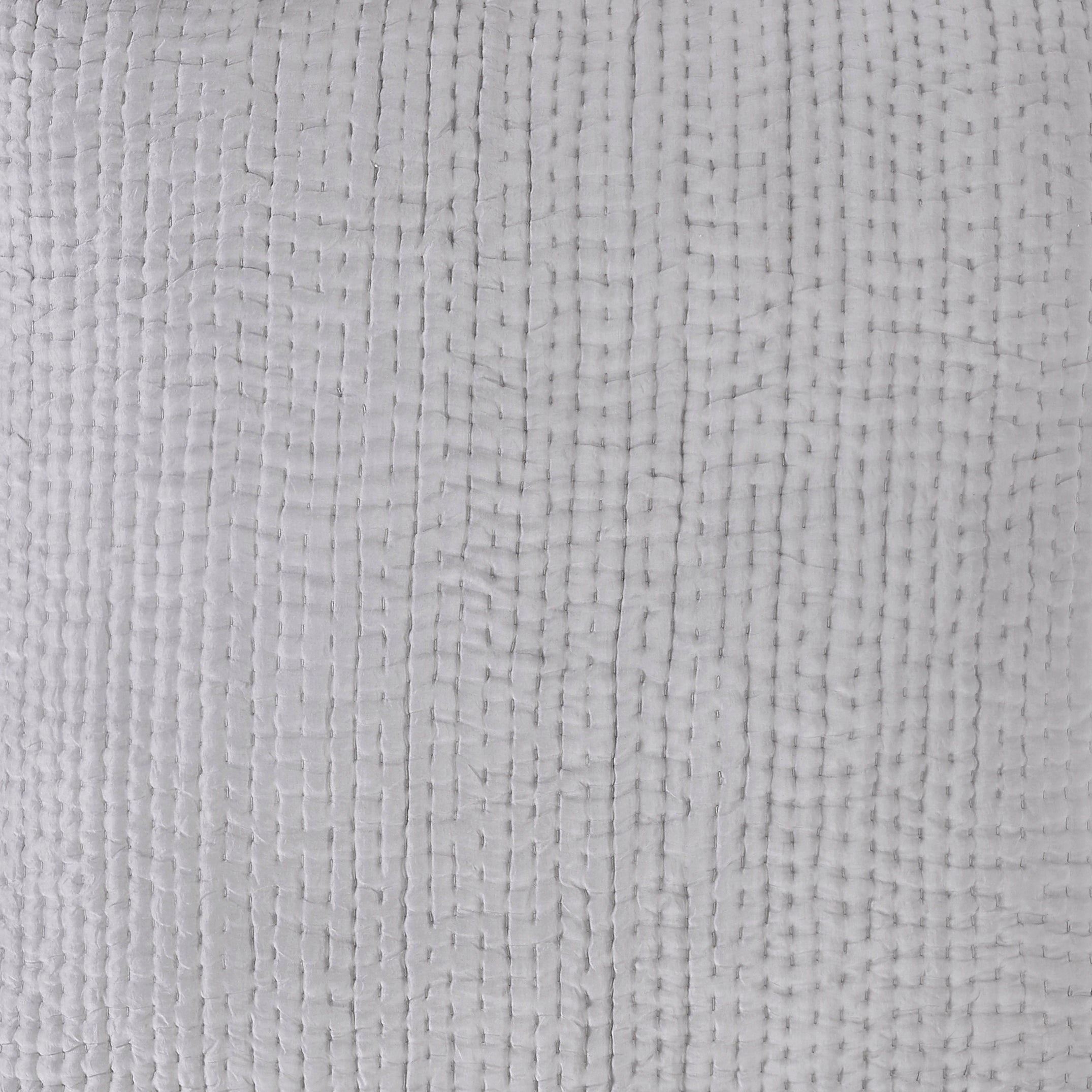 ES-156-2626_3|Close-up of a light grey quilted coverlet fabric. Features a small, dense grid pattern with prominent vertical stitching and soft, woven texture.