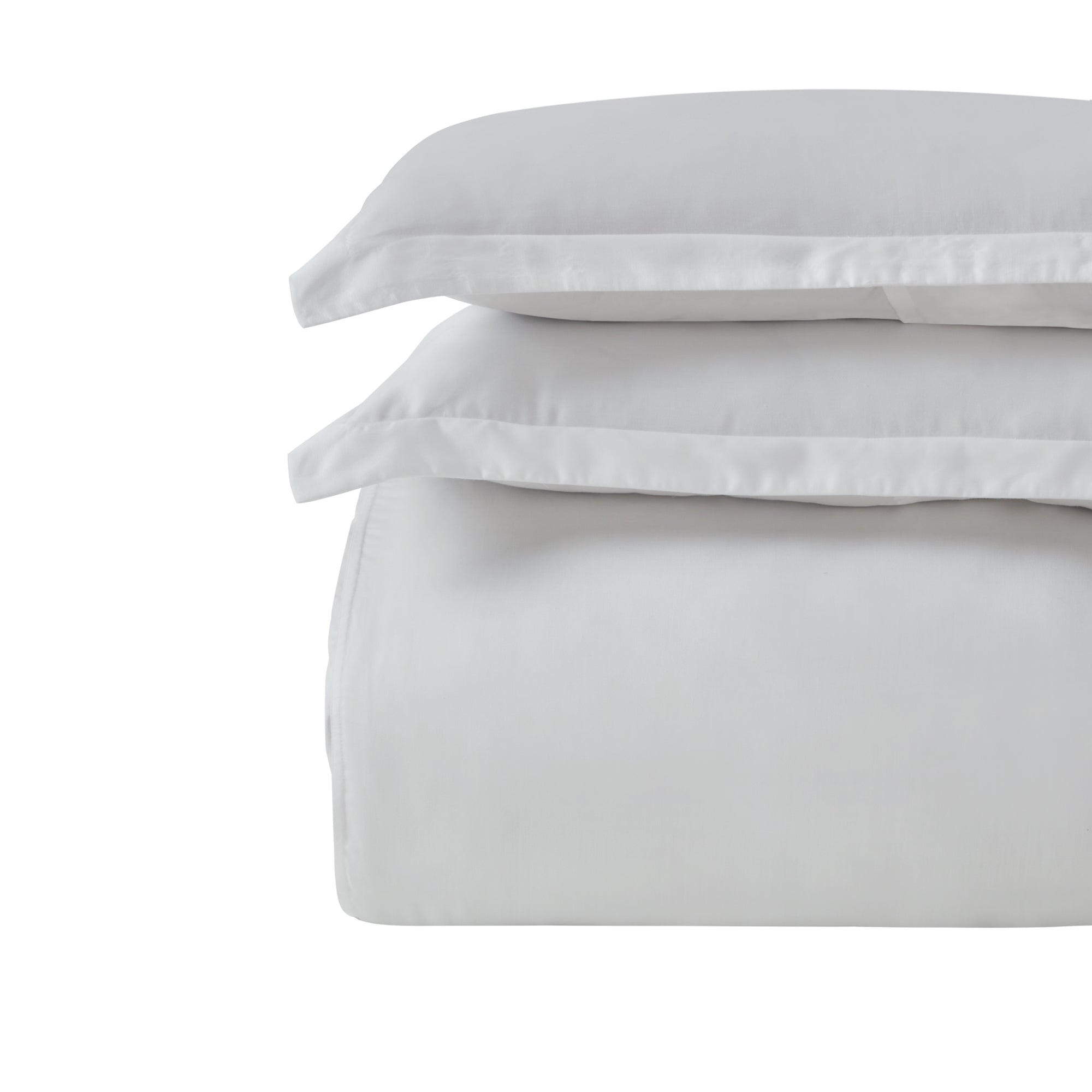 DT-047-10692_6|Stack of fresh white duvet cover and pillowcases, highlighting their soft texture and timeless appeal for any bed.