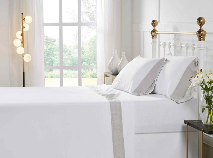 CSS-518-7284_6|Luxurious white 100% linen sheet set on a bed, complete with pillowcases featuring a chic natural grey trim.
