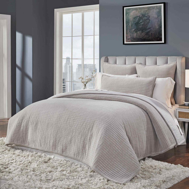 CL-188-9496_4|Side view of a modern bed featuring a plush grey quilted coverlet with a defined channel stitch pattern.