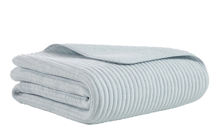 QT-369-9496_5|Folded light blue quilt with a ribbed texture, perfect for modern bedroom decor. Soft and comfortable bedding for a serene look.