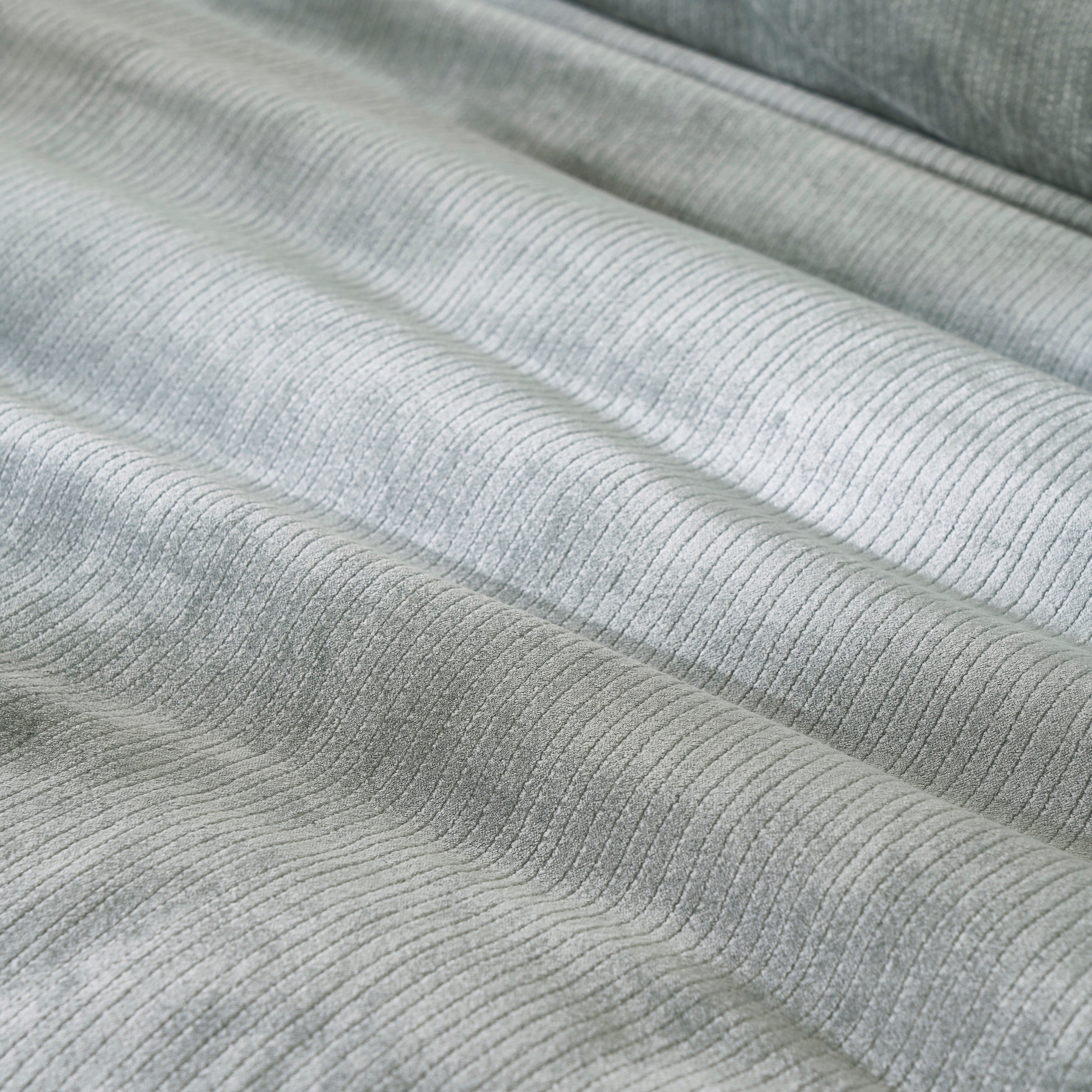 DT-054-10692_6|Plush light green ribbed velvet duvet cover fabric with elegant folds, highlighting its soft and inviting texture.