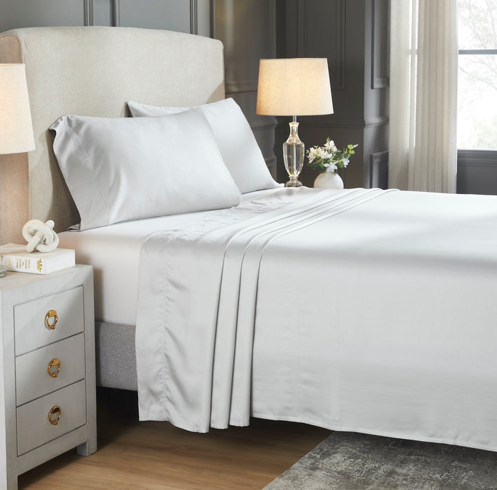 CSS-528-7284_2|Luxurious white 100% Lyocell sheets draped on a bed, providing a silky smooth, breathable, and eco-friendly sleep experience.