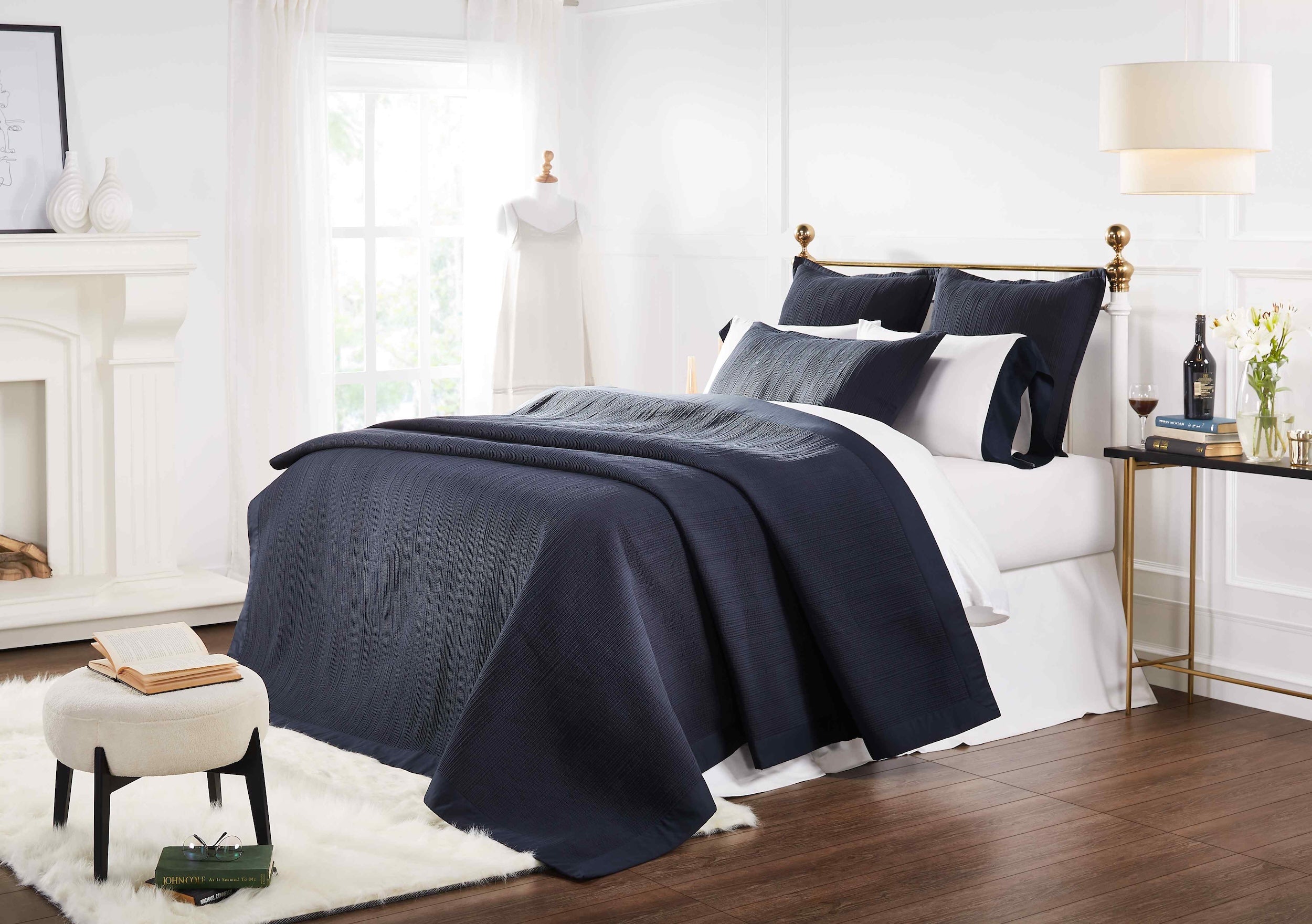 CL-167-11096_2|Navy blue coverlet and matching shams creating a luxurious, textured look for a modern bedroom. Soft, ribbed pattern coverlet.