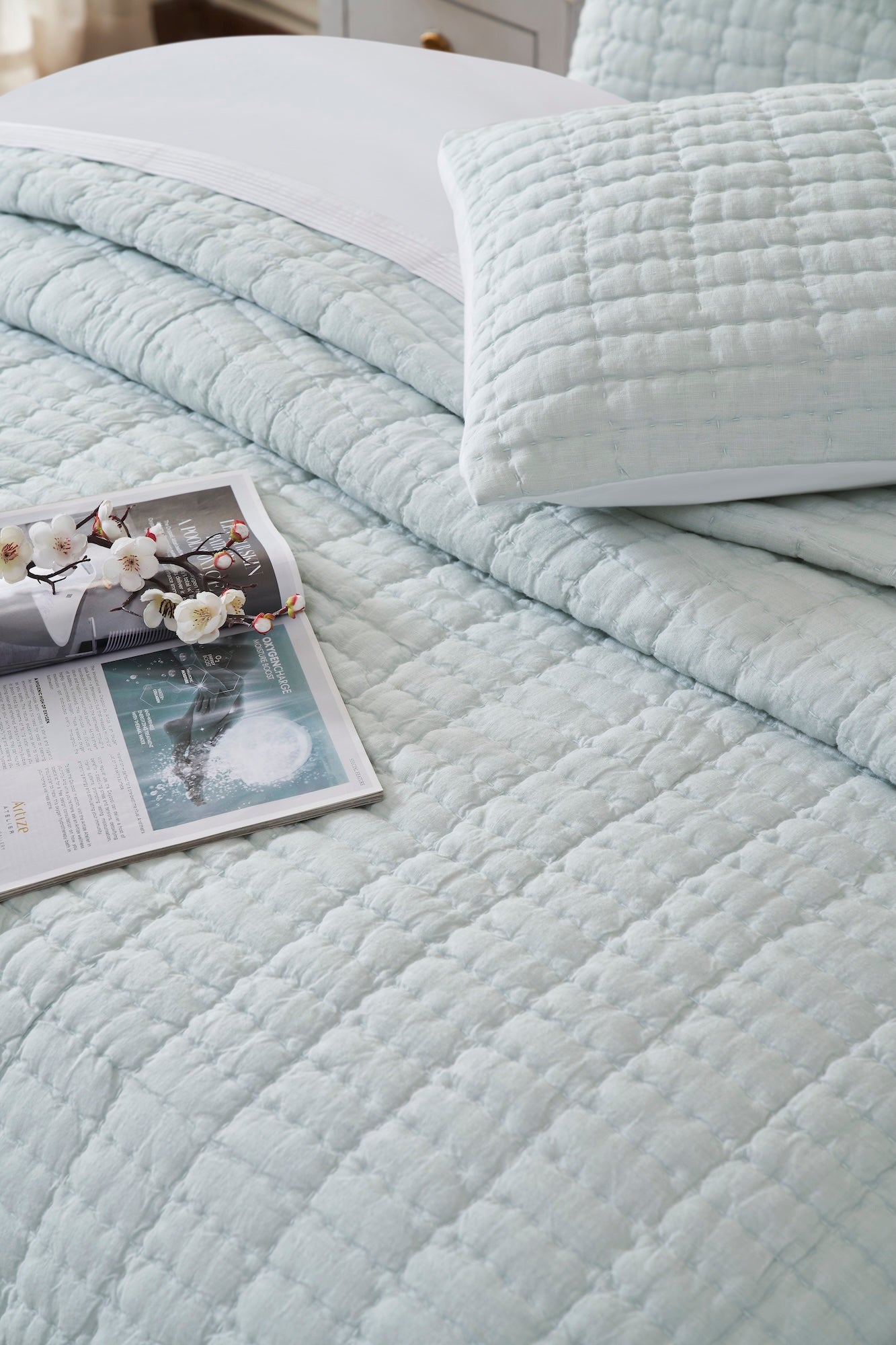 QT-373-11096_4|Light blue textured quilt set on a bed, paired with a matching pillow sham, enhancing bedroom decor.
