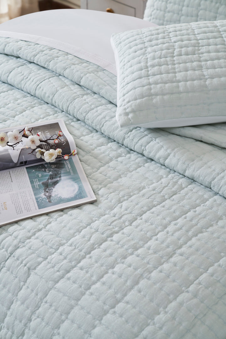 QT-373-11096_4|Light blue textured quilt set on a bed, paired with a matching pillow sham, enhancing bedroom decor.