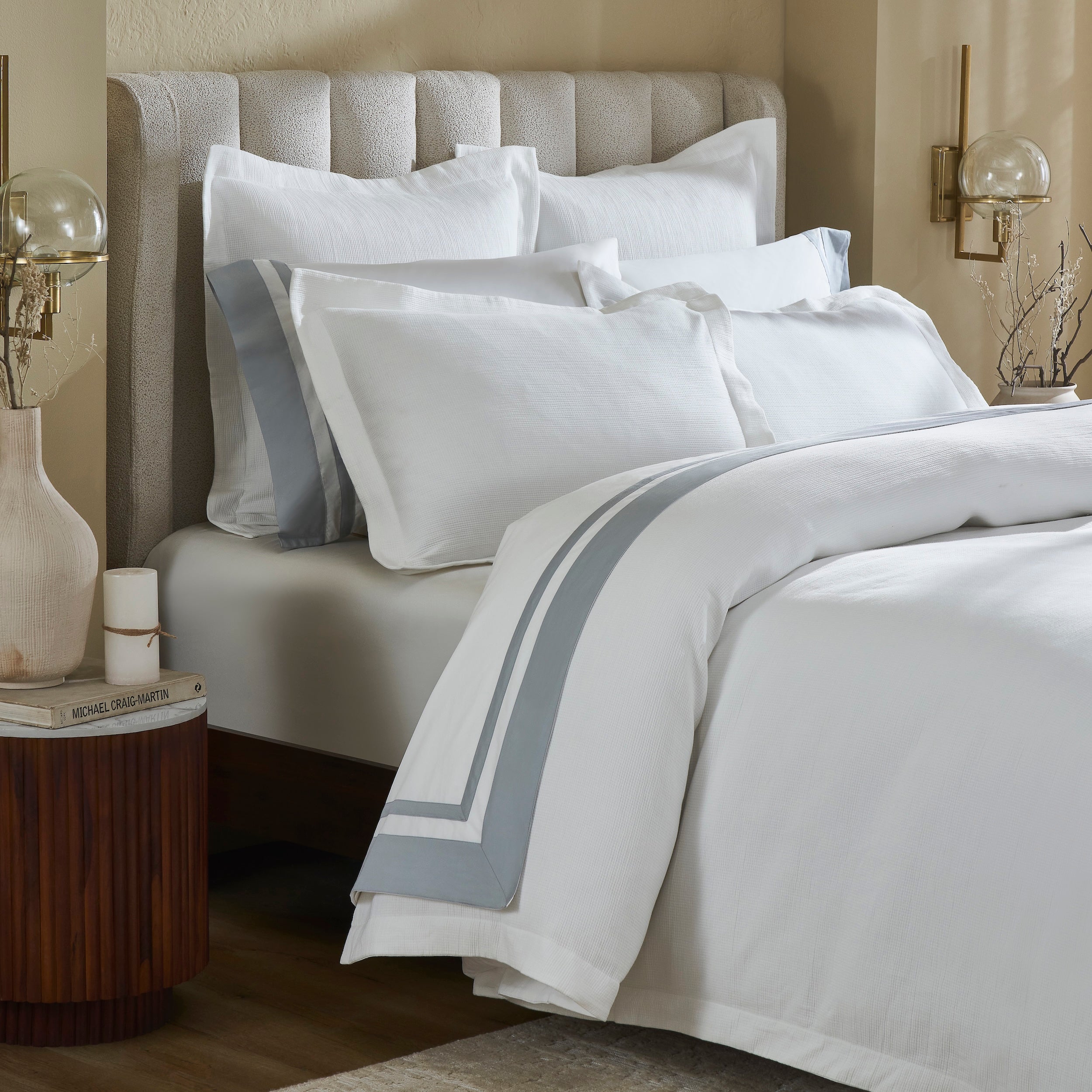 DT-067-9092_4|Elegant white textured duvet cover featuring a sophisticated grey stripe border, beautifully draped on a stylish bed.