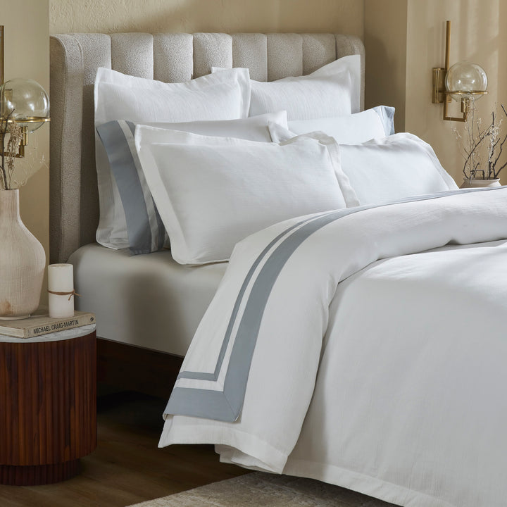 DT-067-9092_4|Elegant white textured duvet cover featuring a sophisticated grey stripe border, beautifully draped on a stylish bed.
