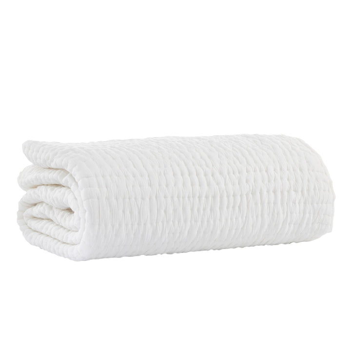 QT-359-9496-LOT1_5|Neatly folded pure white quilted cotton blanket, highlighting its soft texture and elegant stitched design. Perfect for warmth.