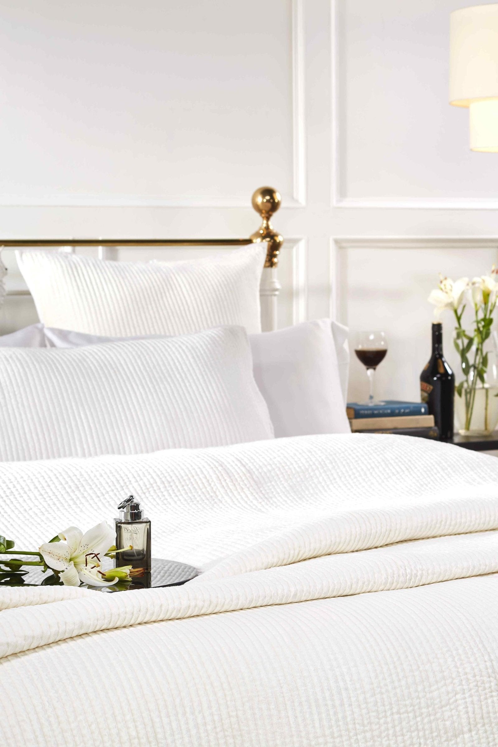 CL-157-X_2|White quilted bedspread set with textured pattern, soft pillows, and gold headboard. Cozy bedroom decor.